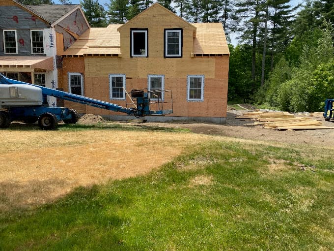 Two storey garage addition under construction, with dormer windows framed into the second floor