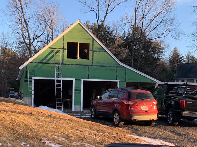 Two car garage with a loft under construction over the winter, sheathed and ready for siding